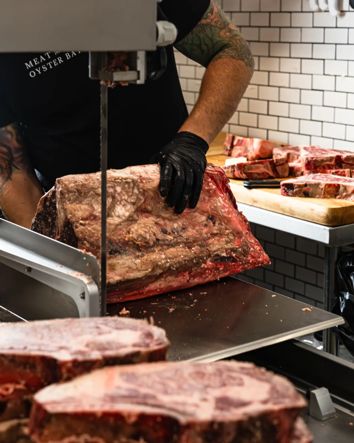 A subprimal at the saw, branded apron in frame