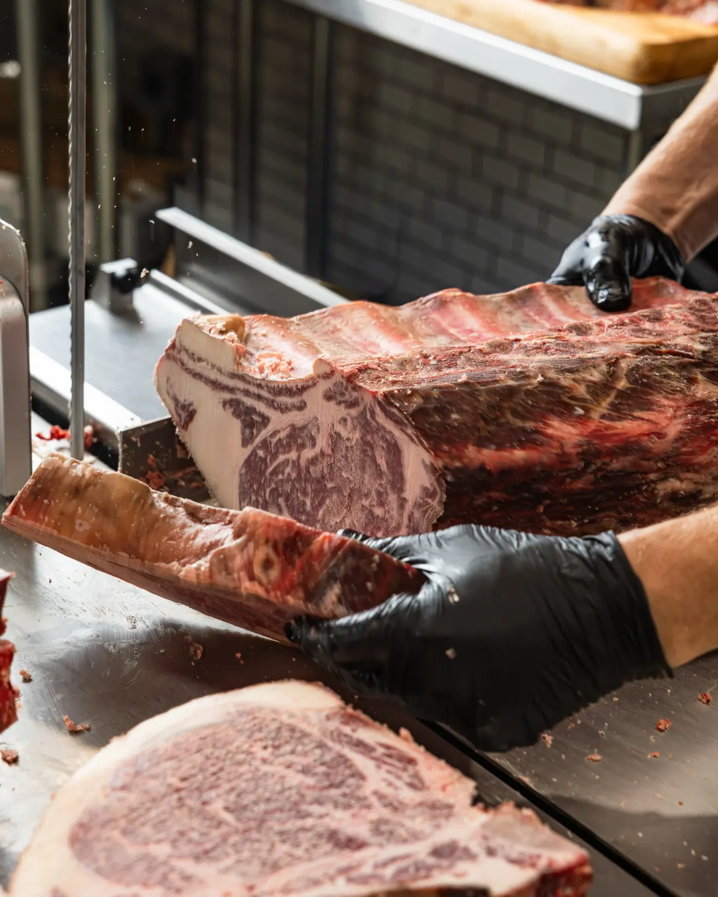 A marbled ribeye coming off the band saw