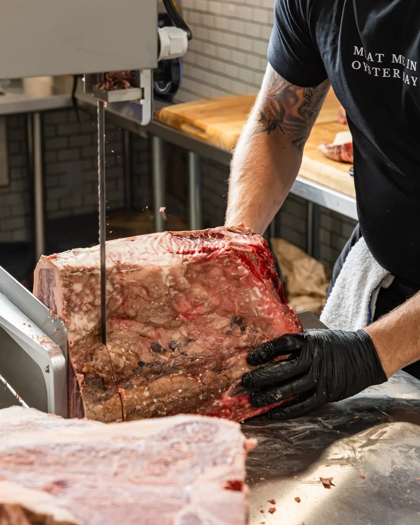 A whole beef primal being broken down on the band saw