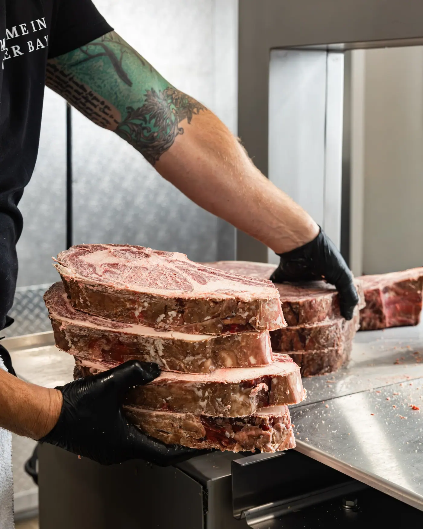 Ribeye steaks stacked by hand