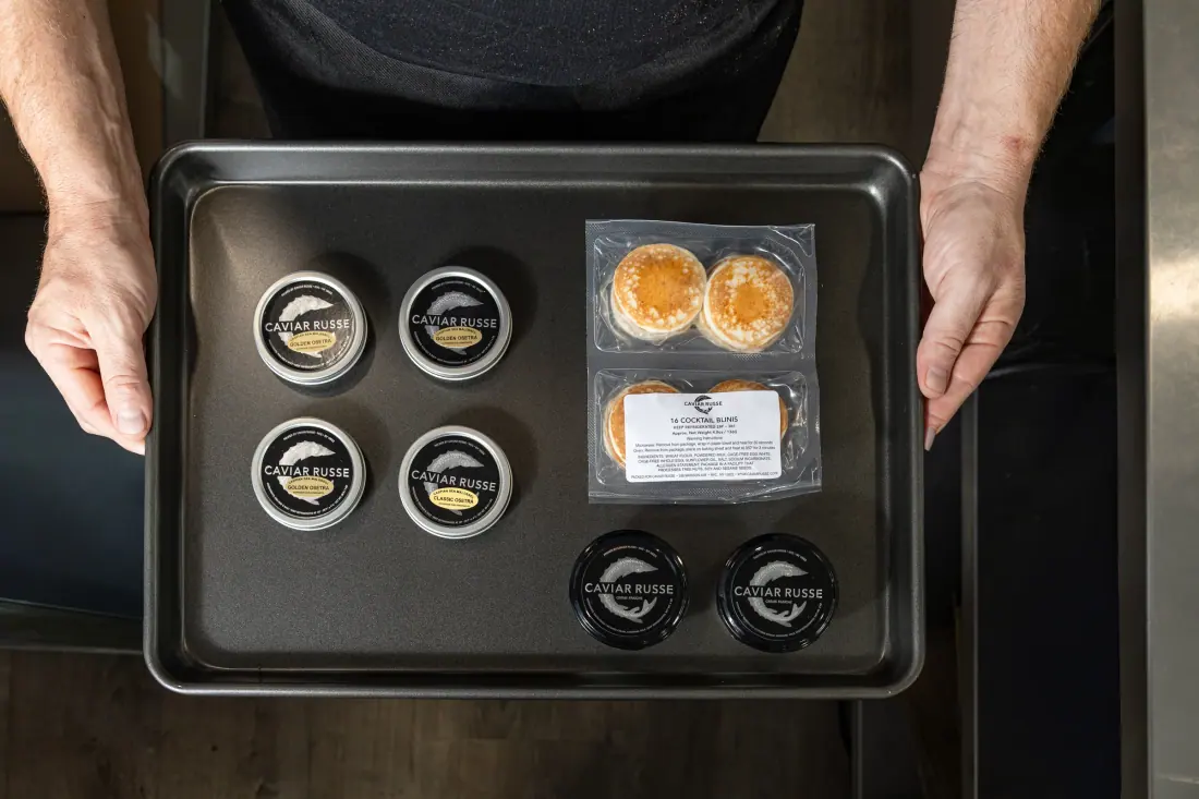 Tins of caviar with blinis, from above