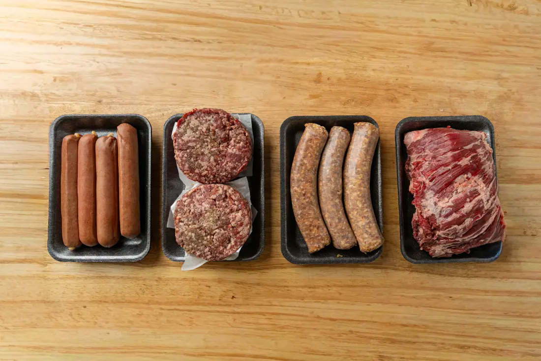 Trays of house sausage and Prime burgers