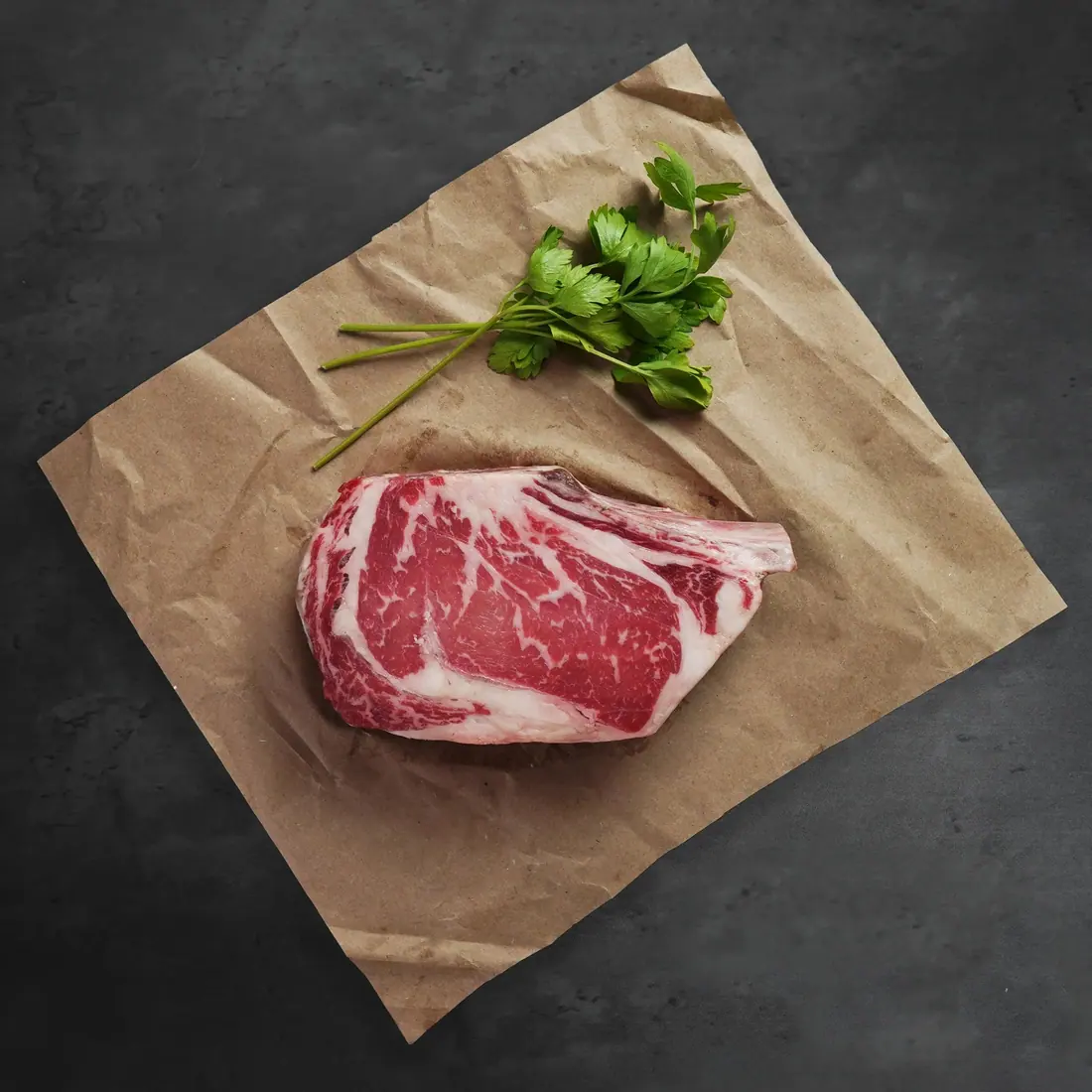 A bone-in dry-aged ribeye cut to order